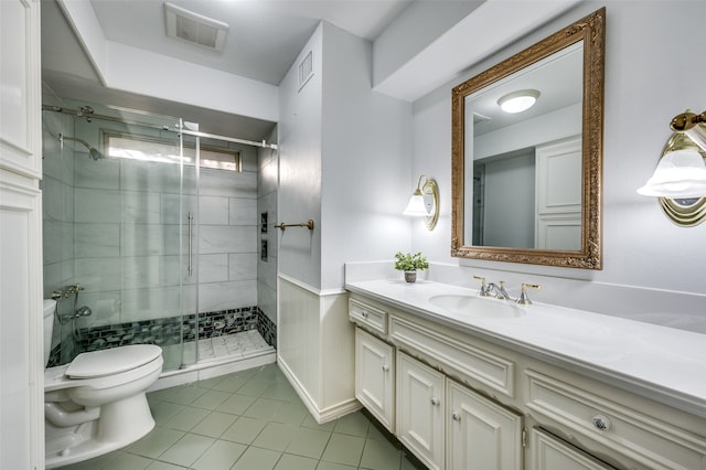 bathroom featuring walk in shower, tile flooring, vanity, and toilet