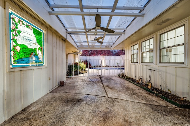 unfurnished sunroom featuring ceiling fan