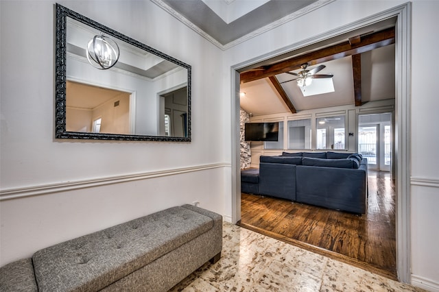 interior space featuring crown molding, an inviting chandelier, hardwood / wood-style floors, and vaulted ceiling with skylight