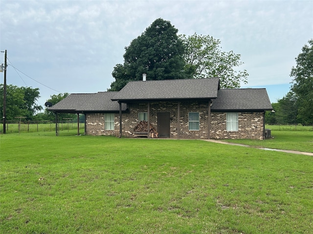 ranch-style home with a front yard and cooling unit