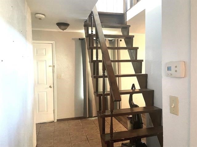 stairway with tile patterned floors