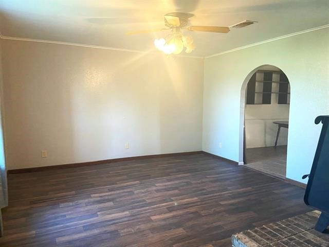 empty room featuring crown molding, ceiling fan, and dark hardwood / wood-style floors