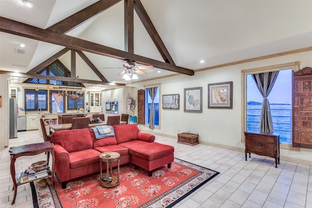 tiled living room with beam ceiling, ceiling fan, sink, and high vaulted ceiling