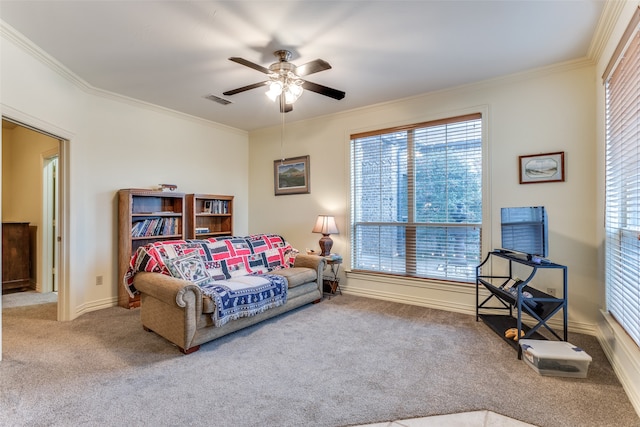 living room featuring carpet floors, ceiling fan, and crown molding