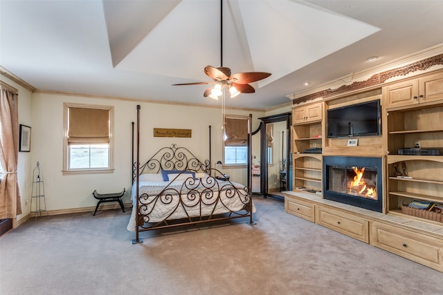 bedroom with carpet flooring, ceiling fan, and crown molding