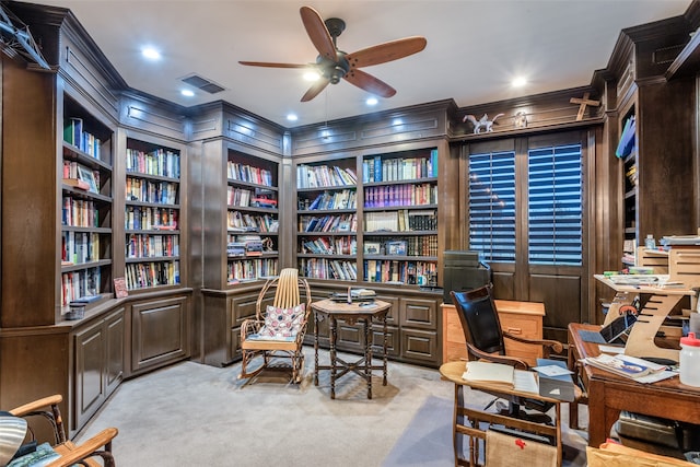 office space with light carpet, built in features, ceiling fan, and wood walls