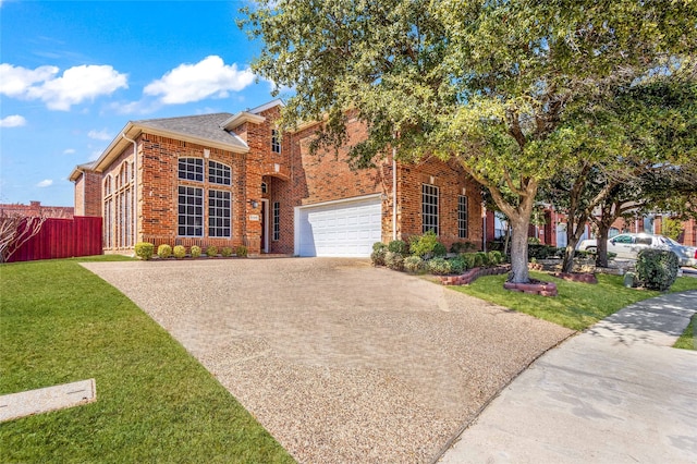 view of front of house featuring a front yard, brick siding, driveway, and fence