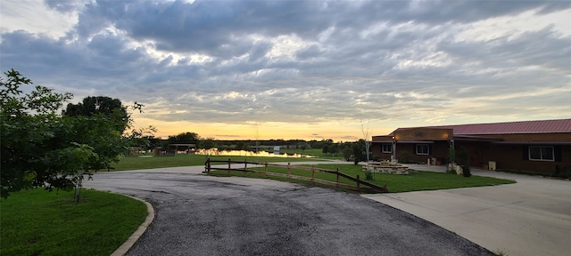 view of community with a lawn and a water view