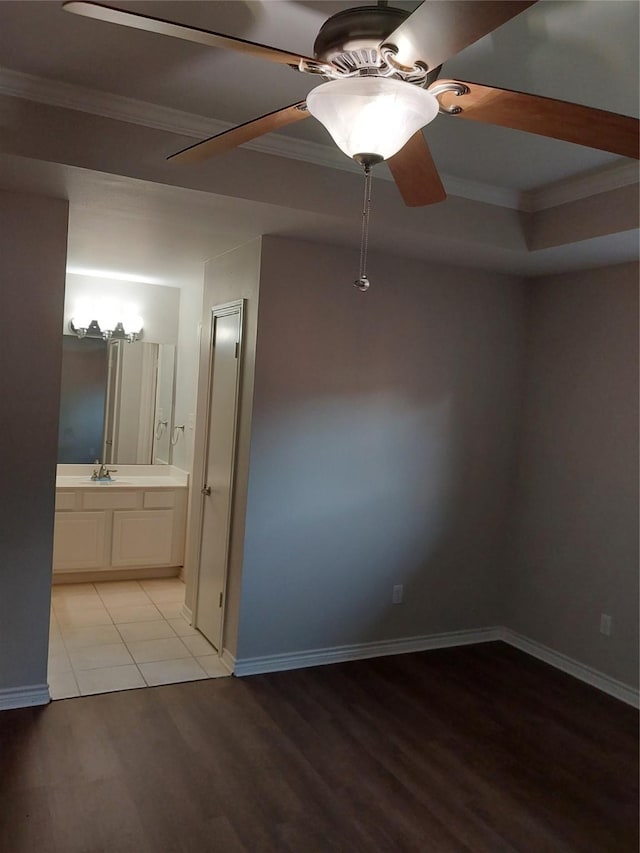 empty room featuring light wood-type flooring, ceiling fan, and crown molding