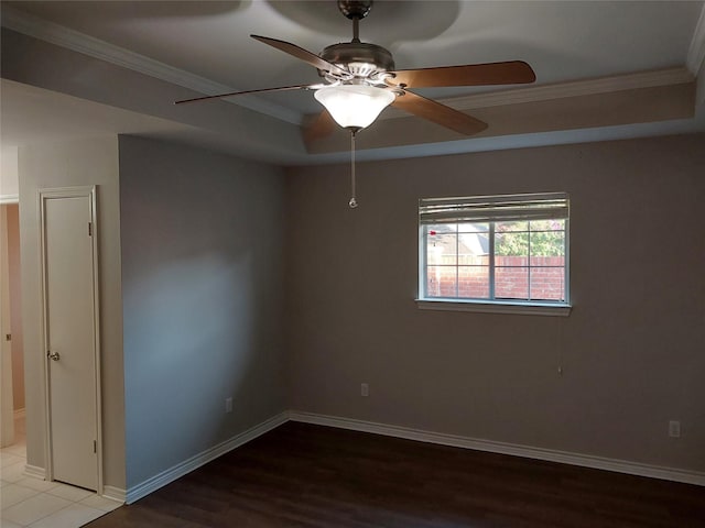 empty room with ceiling fan, hardwood / wood-style flooring, and crown molding