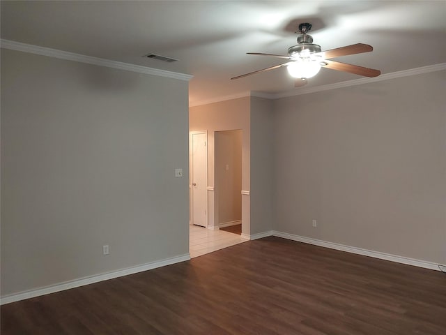 empty room featuring hardwood / wood-style flooring, crown molding, and ceiling fan