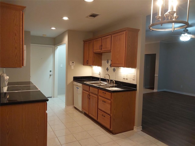 kitchen with tasteful backsplash, dishwasher, pendant lighting, light tile patterned flooring, and sink