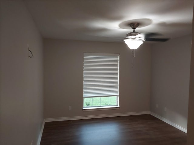 empty room with ceiling fan and dark hardwood / wood-style flooring