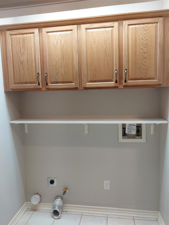 laundry area featuring gas dryer hookup, washer hookup, light tile patterned floors, electric dryer hookup, and cabinets