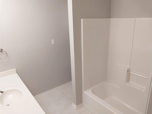 bathroom with tub / shower combination, vanity, and tile patterned flooring