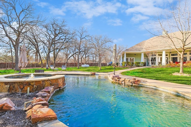 view of swimming pool with ceiling fan and a yard