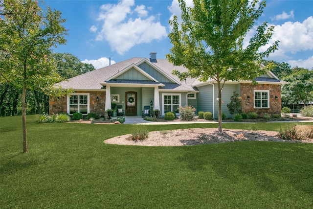 craftsman inspired home with a front lawn