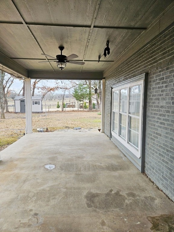 view of patio / terrace featuring ceiling fan and a storage unit