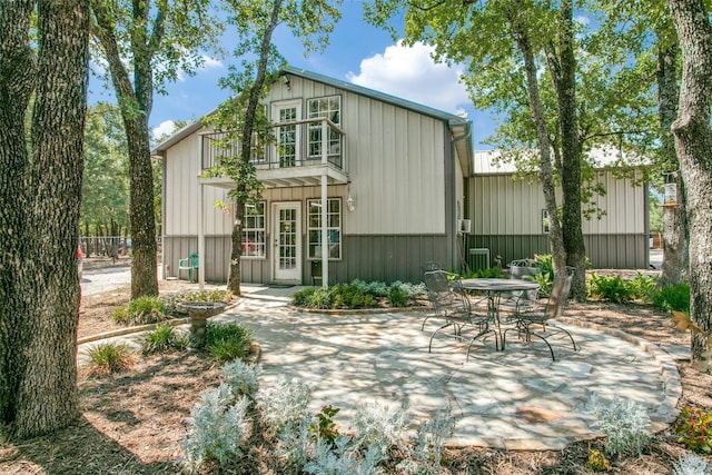 rear view of house with a balcony and a patio area