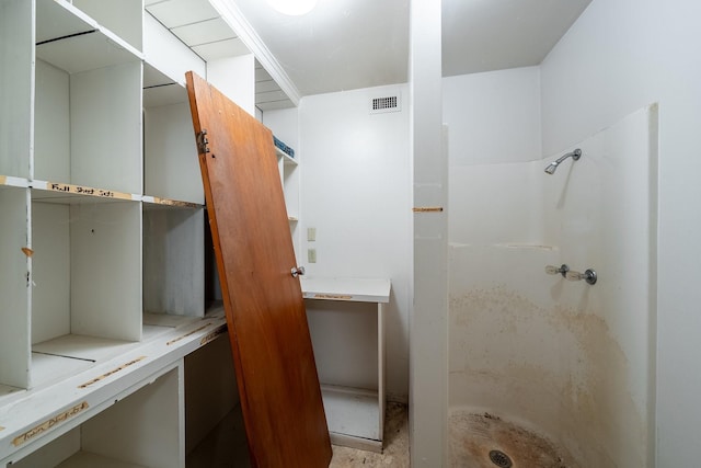 bathroom with a stall shower and visible vents