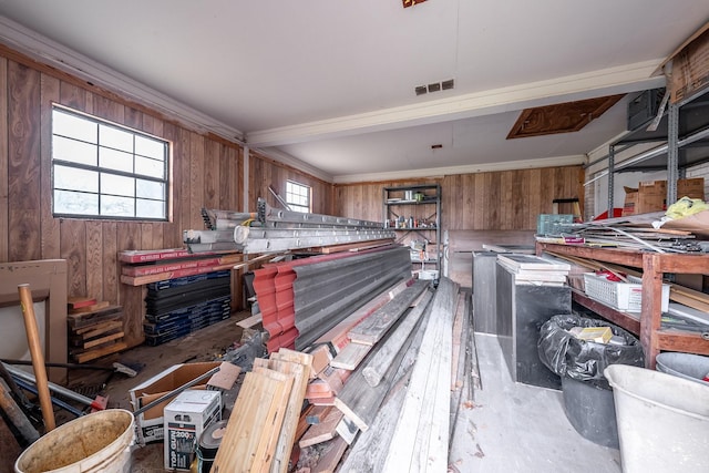 interior space with wood walls, visible vents, and brown cabinets