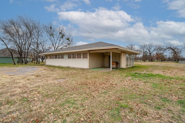 view of side of home with a lawn