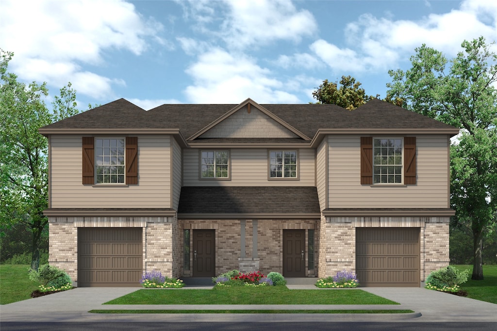 view of front of property featuring a front yard and a garage