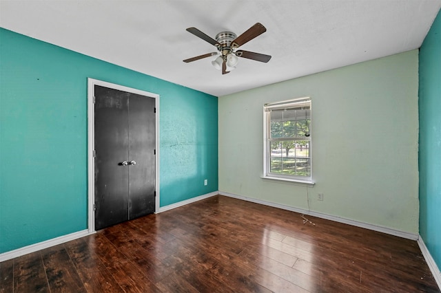 unfurnished bedroom featuring a closet, wood-type flooring, and ceiling fan