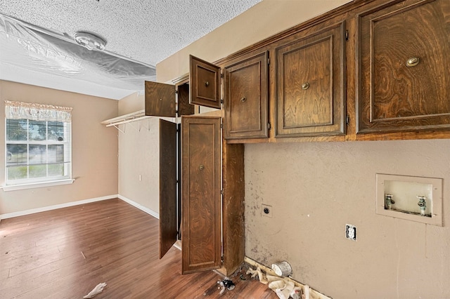 kitchen featuring a textured ceiling and dark wood-type flooring