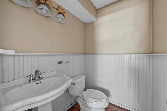 bathroom featuring hardwood / wood-style floors, sink, and toilet