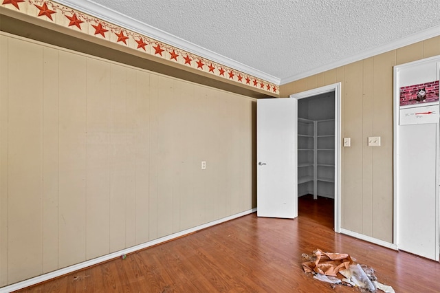 unfurnished bedroom with crown molding, hardwood / wood-style floors, and a textured ceiling