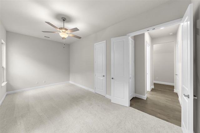 unfurnished bedroom featuring ceiling fan and carpet floors