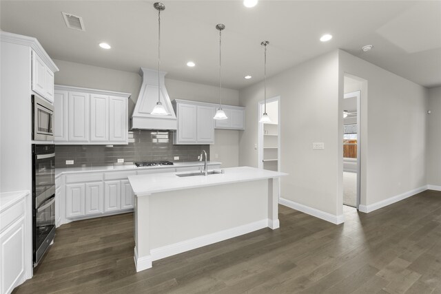 kitchen featuring custom range hood, white cabinetry, dark hardwood / wood-style flooring, and sink