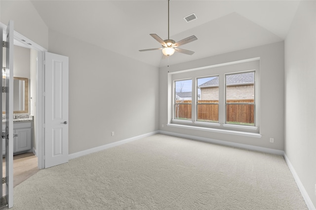 unfurnished bedroom with ceiling fan, light carpet, and lofted ceiling