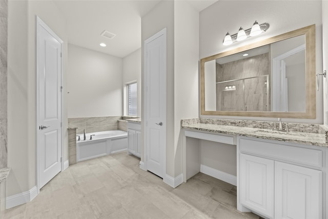 bathroom with plus walk in shower, vanity, and tile patterned floors