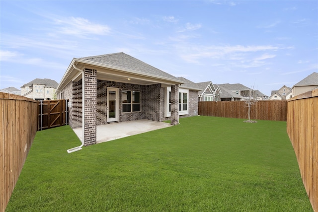 back of house with a lawn and a patio area