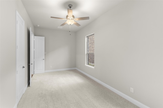 carpeted empty room featuring ceiling fan