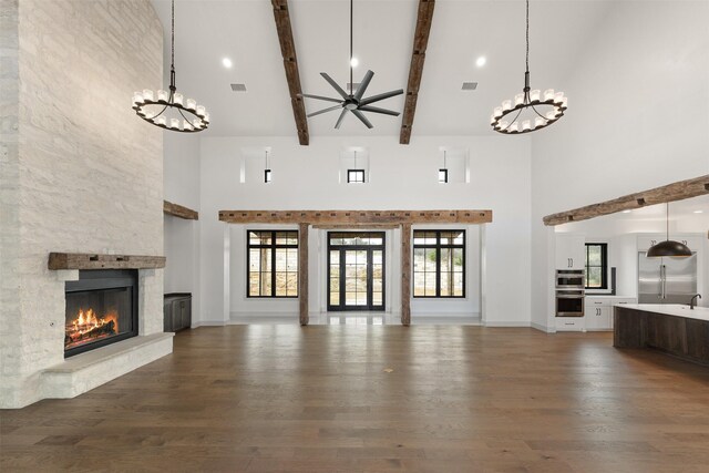 empty room with hardwood / wood-style floors, a wealth of natural light, and a water view