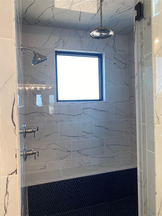 bathroom with a tile shower