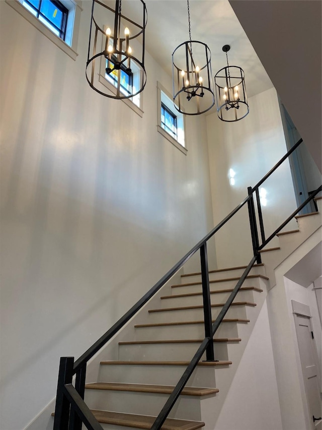 staircase featuring a towering ceiling