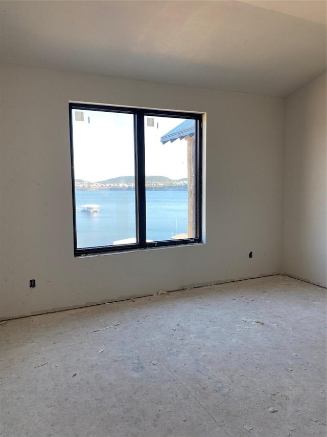 unfurnished room with a water view