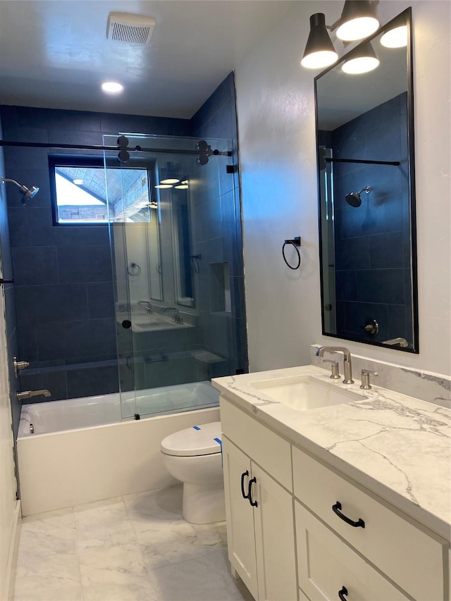 full bathroom featuring vanity, shower / bath combination with glass door, and toilet