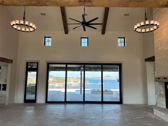 interior space featuring beam ceiling, an inviting chandelier, concrete floors, and high vaulted ceiling