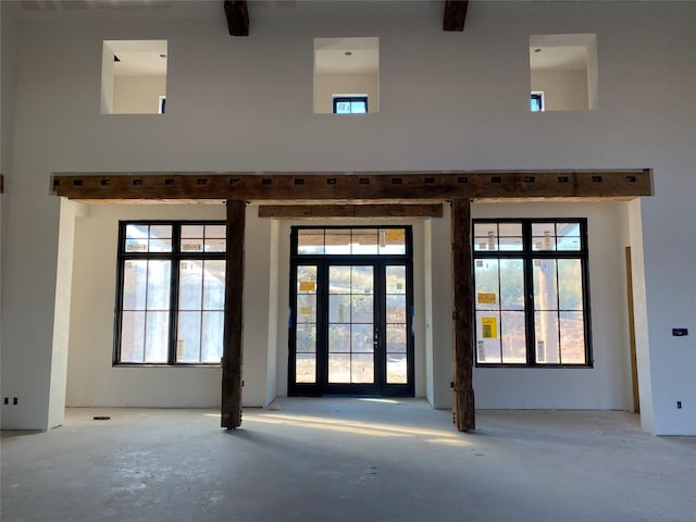 interior space featuring french doors and concrete floors