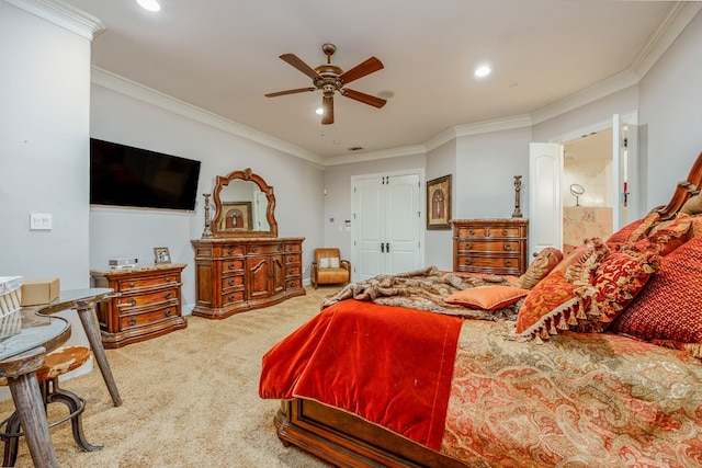 bedroom with ceiling fan, ornamental molding, light colored carpet, and ensuite bath