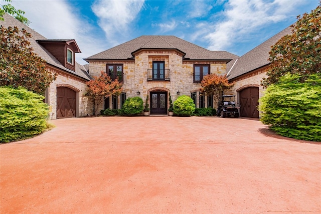 french country inspired facade featuring a garage