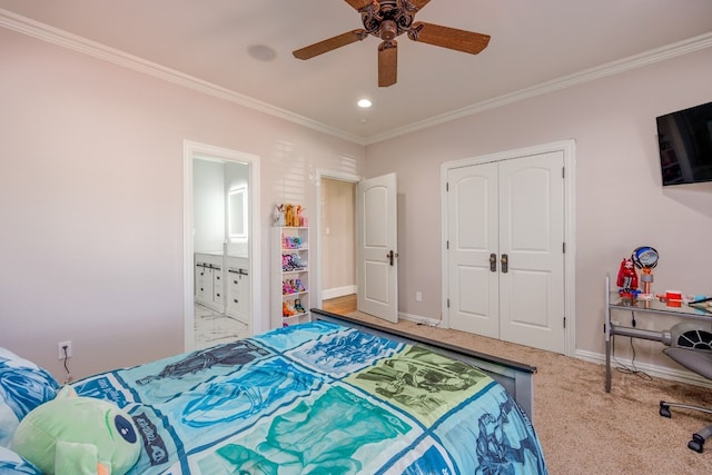 carpeted bedroom with a closet, ensuite bath, ceiling fan, and ornamental molding