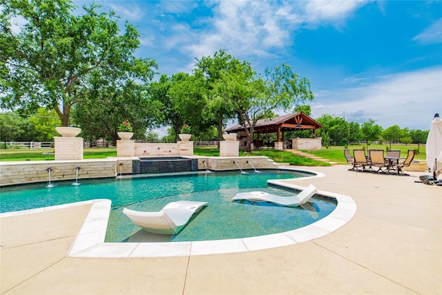 view of swimming pool with a patio, a gazebo, an in ground hot tub, and pool water feature