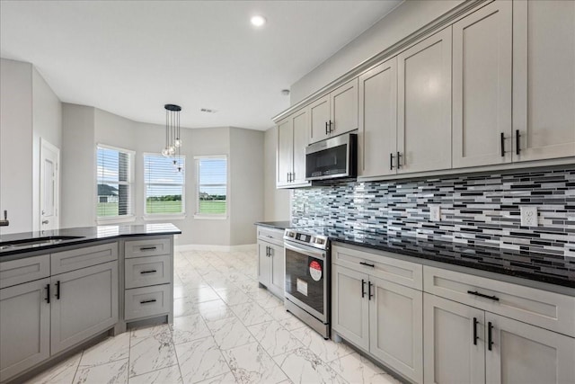 kitchen featuring sink, backsplash, appliances with stainless steel finishes, and gray cabinets