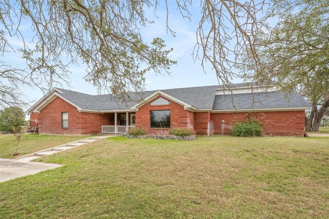 ranch-style home featuring a porch and a front yard